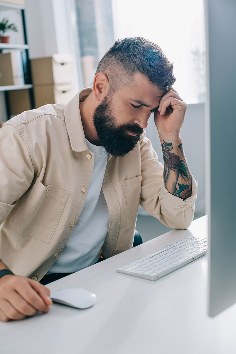 man sitting at computer